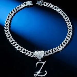 Close-up of iced-out heart necklace featuring a cursive letter Z diamond pendant.