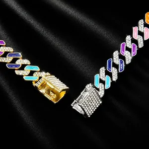 Close-up of colorful rhinestone-encrusted Cuban link chains in gold and silver.