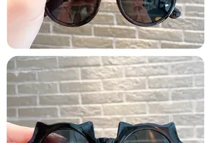 Detailed view of stylish black cat-ear sunglasses for kids featuring UV protection.
