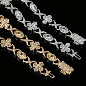 Detailed close-up view of iced out hip-hop necklace with cross and eye pendants.