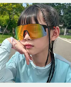 Close-up of a child wearing orange iridescent cycling sunglasses in an outdoor park