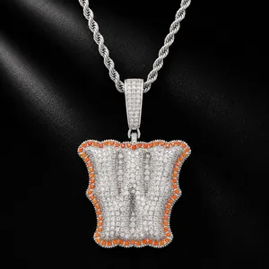 Detailed macro view of a silver iced-out bone letter W pendant with orange border