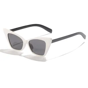 Side view of retro cat-eye sunglasses featuring white frames and dark tinted lenses