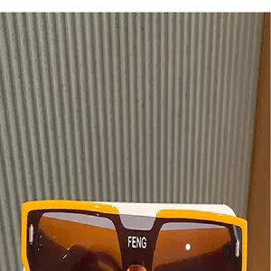 Primer plano detallado de gafas de sol cuadradas modernas con montura naranja