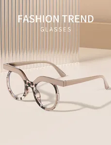 Close-up of retro round glasses with unique beige bridge and tortoiseshell frame detail