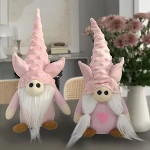 Detail showing two pink plush gnomes with pig ears and heart motif for Valentine's Day