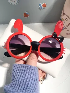 Detailed view of red rabbit-shaped children's sunglasses featuring cute ear and bow decorations