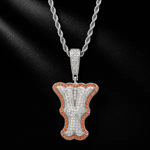 Iced out bone-style letter I pendant necklace with orange and white CZ stones.