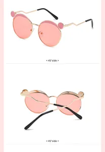 Detail view showing 45-degree side angles of pink round kids metal sunglasses