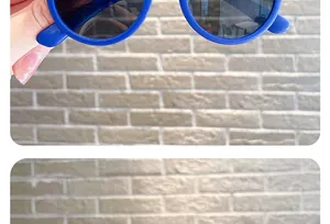 Close-up detail of blue round children's sunglasses with UV protection lenses.