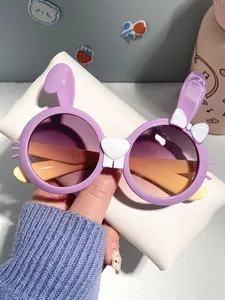 Close-up of cute purple rabbit shaped cartoon sunglasses for children with white bow detail