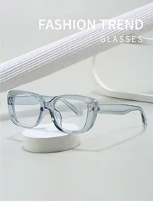 Close-up detail of stylish transparent light blue square glasses with silver studs