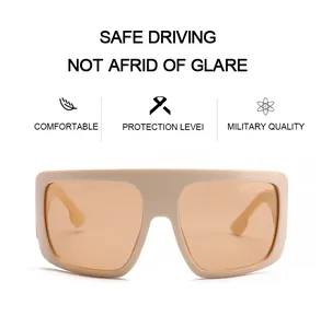 Frontal macro view of oversized cream retro shield sunglasses with stylish amber lenses