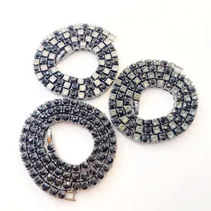 Close-up detail of 5mm single row rhinestone tennis chains in classic black and white colors