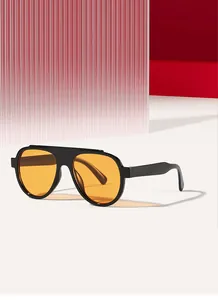 Detailed side view of oversized black aviator sunglasses featuring vibrant orange lenses