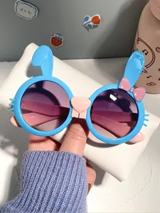 Close-up detail of cute blue bunny shaped cartoon sunglasses for children with gradient lenses
