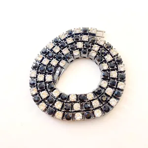 Macro detail of a 5mm tennis chain with alternating black and white rhinestones
