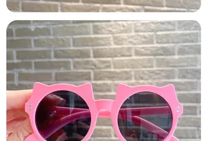 Detail of cute pink cat-ear sunglasses for kids with dark lenses
