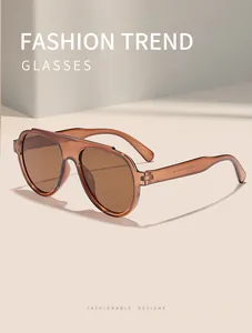 Detail view of tea-colored oversized sunglasses with transparent frames and UV protection