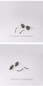 Close-up of children's metal cat-ear sunglasses with black lenses and gold frames.