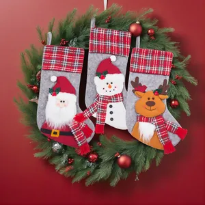 Set of 3 Christmas stockings with Santa, Snowman, and Reindeer designs on a festive wreath.