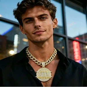 Detailed view of gold-tone iced out hip hop chain with King of Kings pendant on male model