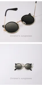 Close-up detail of stylish children's cat-ear sunglasses with gold metal frame finish