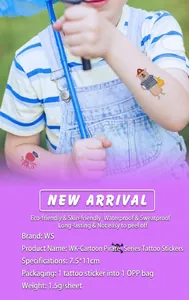 Close-up of kids' cartoon pirate tattoo stickers applied on a child's arm outdoors
