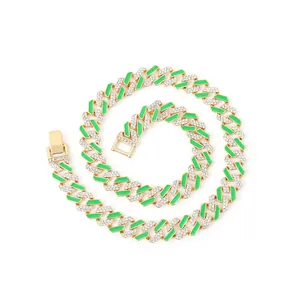 Close-up of 12mm gold Cuban link chain with green enamel and sparkling rhinestones