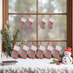 Detailed view of mini colorful knitted Christmas stockings hanging in a festive window scene