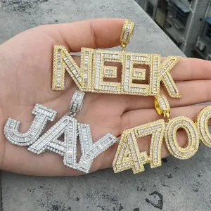 Close-up of gold and silver hip hop letter pendants with iced out cubic zirconia stones.