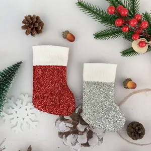 Detailed view of mini red and silver glitter Christmas stockings for tree decorations