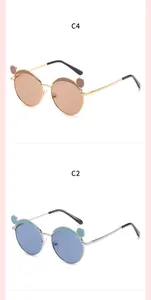 Detail of children's metal sunglasses with cute bear ear design in brown and blue