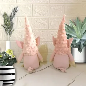 Back view of pink gnome plush pigs showing curly tails and textured hats for Valentine's decoration