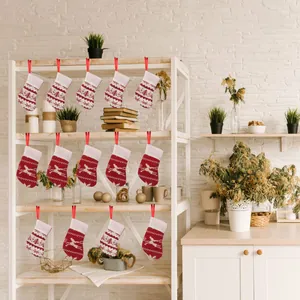 Mini knitted Christmas socks with snowflake and reindeer patterns for festive holiday decor
