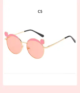 Close-up of children's pink animal ear sunglasses with a stylish gold metal frame