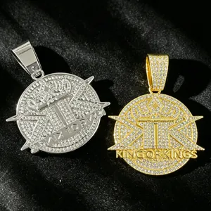 Close-up of gold and silver iced out King of Kings pendants with rhinestones