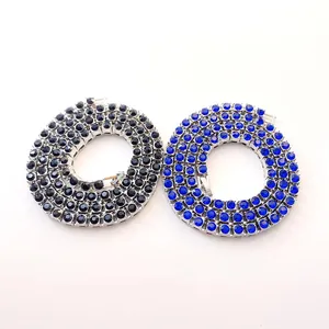 Detailed macro view of 5mm hip-hop tennis chains in black and vibrant blue rhinestones