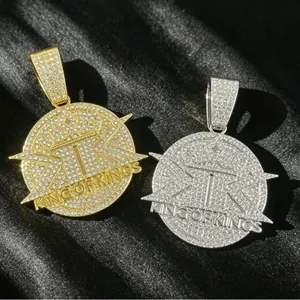 Detailed macro shot of iced out King of Kings hip hop pendants in gold and silver finish