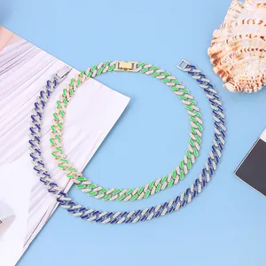 Detailed macro view of 12mm iced-out Cuban link necklaces with green and blue enamel