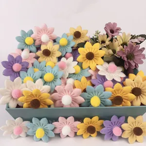 Macro detail of colorful felt sun flowers and daisy decor for festive party events