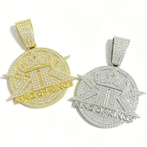 Detail of hip-hop King of Kings crown pendants with pavé crystals in gold and silver finish.