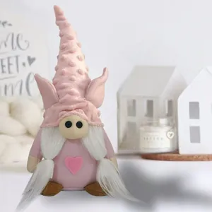Close-up detail of a pink pig-themed Valentine gnome plush doll featuring a heart motif
