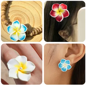 Detail view of colorful clay frangipani flower charms used for DIY jewelry accessories