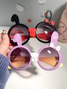Detail view of cute rabbit-shaped sunglasses for children in purple and black colors.