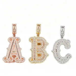 Close-up of iced-out alphabet pendants in gold, rose gold, and silver finishes.