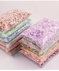 Close-up of various candy colored 4mm acrylic bicone beads in stacked plastic bags