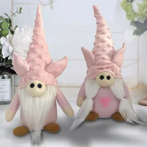 Pair of cute pink Valentine's Day gnomes with pig ears and hearts for desktop decoration