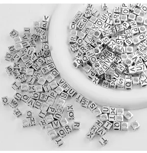 Close-up of 7x7mm silver-plated square alphabet alloy beads for DIY jewelry.