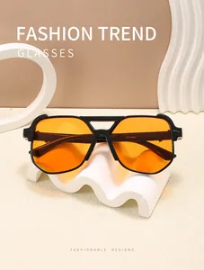 Close-up of retro aviator sunglasses with orange lenses and black double bridge frame